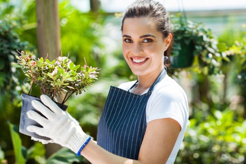 Gardener trimming a suburban hedge in Yiewsley